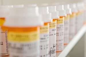 Medication bottles lined up on a shelf